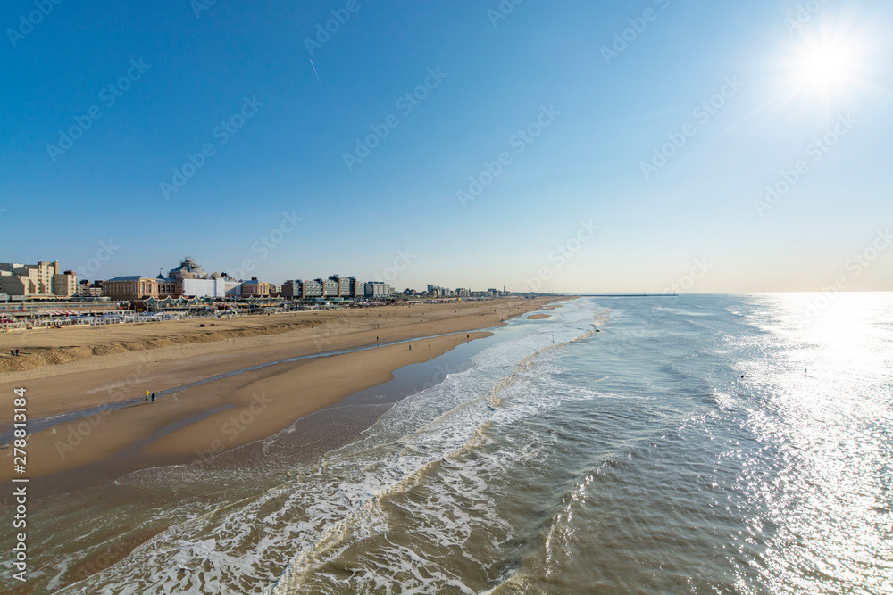 Sunny day on North sea beach in Netherlands in Scheveningen, tourist and vacation destination in Europe Sunny day on North sea beach in Netherlands in Scheveningen, tourist and vacation destination in Europe