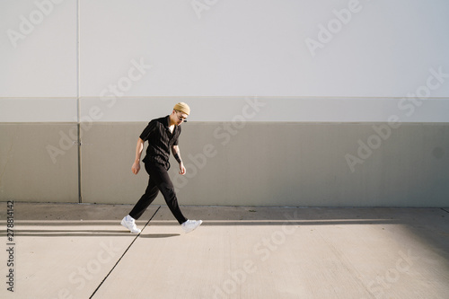 Young man walking outdoors photo