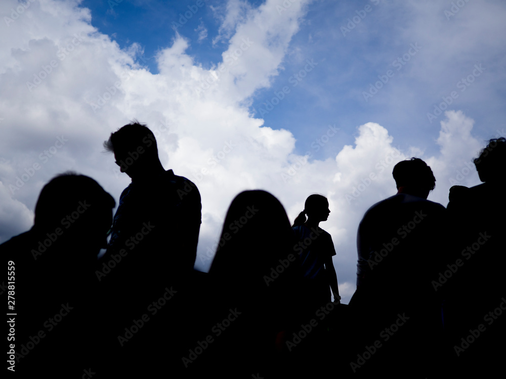 A silhouette of a group of people with in the background