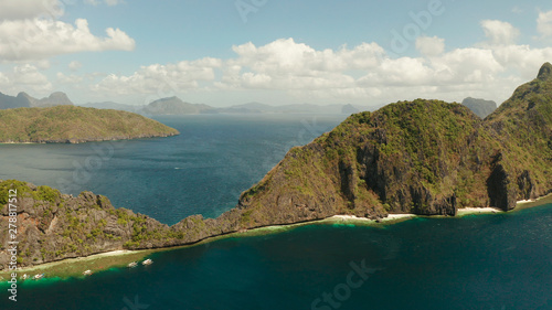 Fototapeta Naklejka Na Ścianę i Meble -  Bay and the tropical islands. Seascape with tropical rocky islands, ocean blue wate, aerial view. islands and mountains covered with tropical forest. El nido, Philippines, Palawan. Tropical Mountain