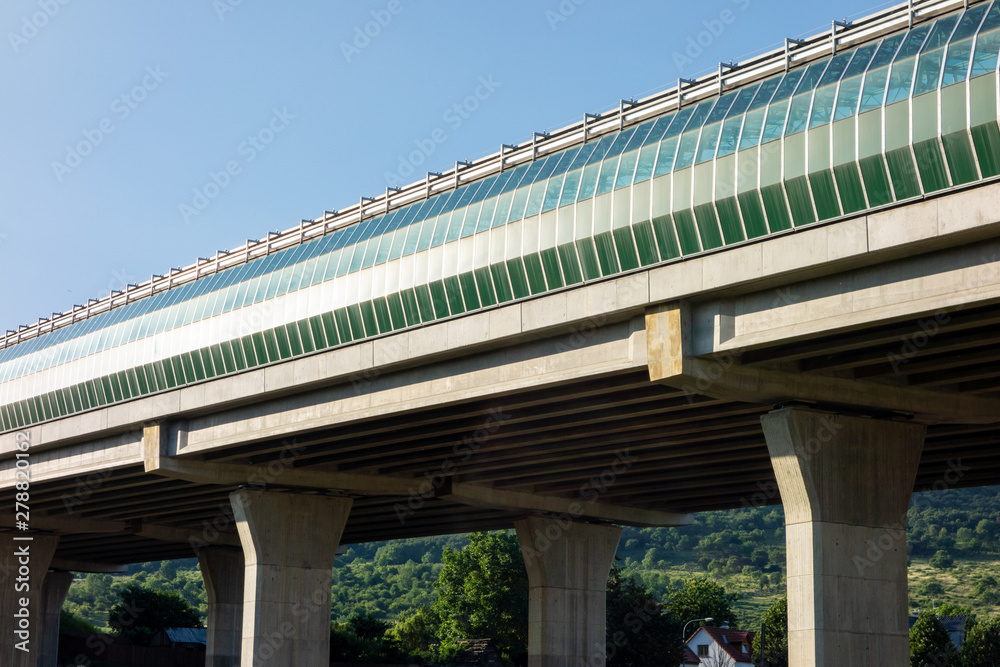 A modern highway bridge covered with glass A modern highway bridge covered with glass
