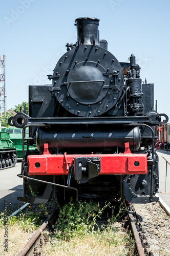 Soviet steam locomotive stands on the platform of the station.