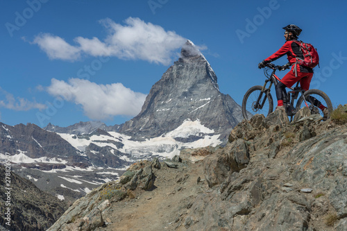 active senior woman, riding her electric mountainbike below the famous Matterhorn in Zermatt, Wallis,Switzerland © Uwe