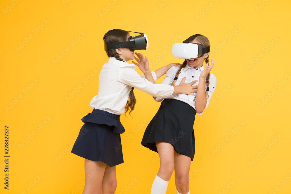 Using VR technologies. children wear wireless VR glasses. future education. back to school. Digital future and innovation. virtual reality. small girls in VR headset. Happy kids use modern technology