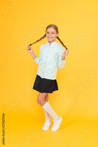 education concept. back to school. knowledge day. childhood happiness. smart little girl on yellow background. happy girl in school uniform. kid fashion. school market. Enjoying student life