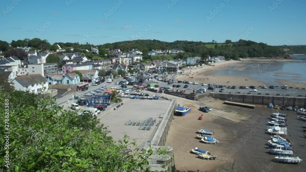 Panning overview of boats and harbour at Saundersfoot Pembrokeshire Wales   