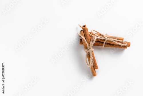 Cinnamon sticks on white background with place for text