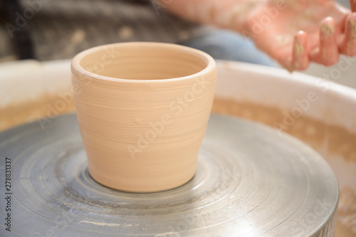 Beautiful clay pot on a potter's wheel