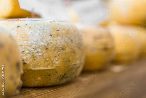 Selection of traditional Italian cheeses on a display, selective focus