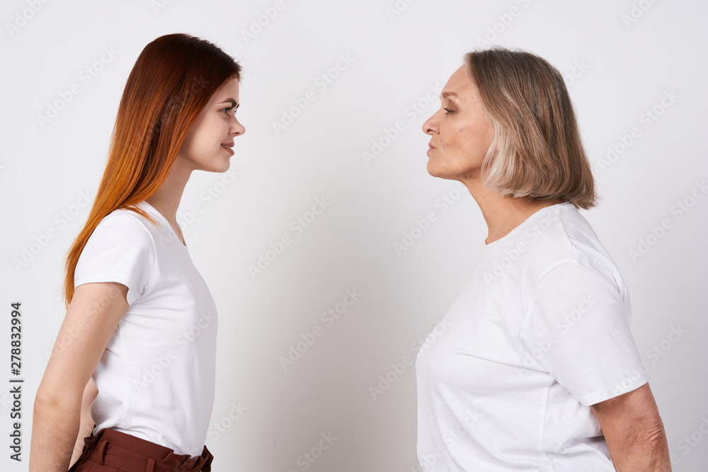 An elderly woman and granddaughter are standing nearby An elderly woman and granddaughter are standing nearby
