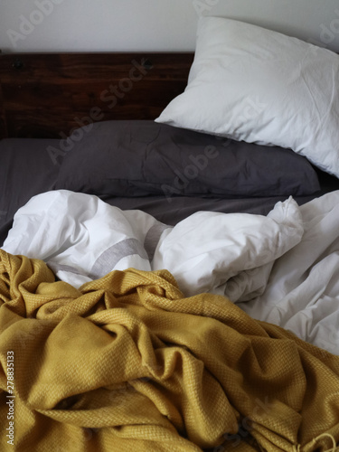 Cozy bed with wooden headboard background 