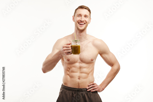 The athlete drinks a healthy smoothie on a white background