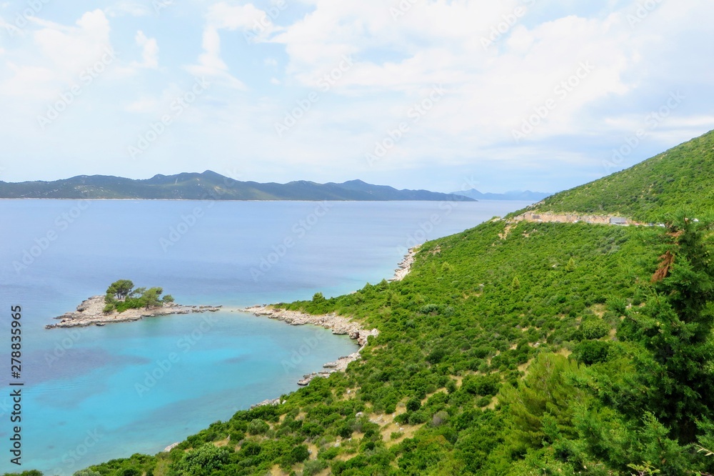 A beautiful view along the Adriatic highway beside a remote turquoise bay along the coast of Croatia outside of Dubrovnik.