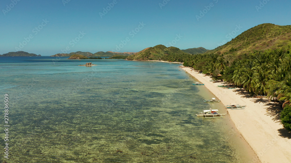 Fototapeta premium Aerial drone small island group in province of Palawan. Busuanga, Philippines. Seascape, islands covered with forest, sea with blue water. tropical landscape, travel concept