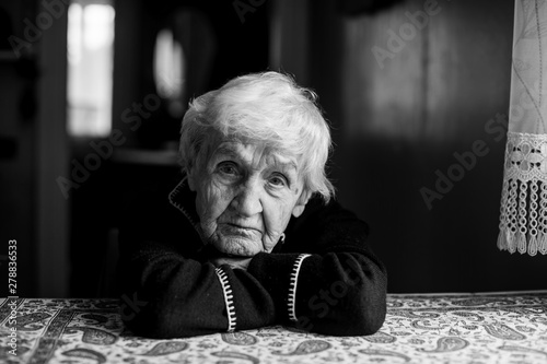 Black and white portrait of a lonely sad old woman.