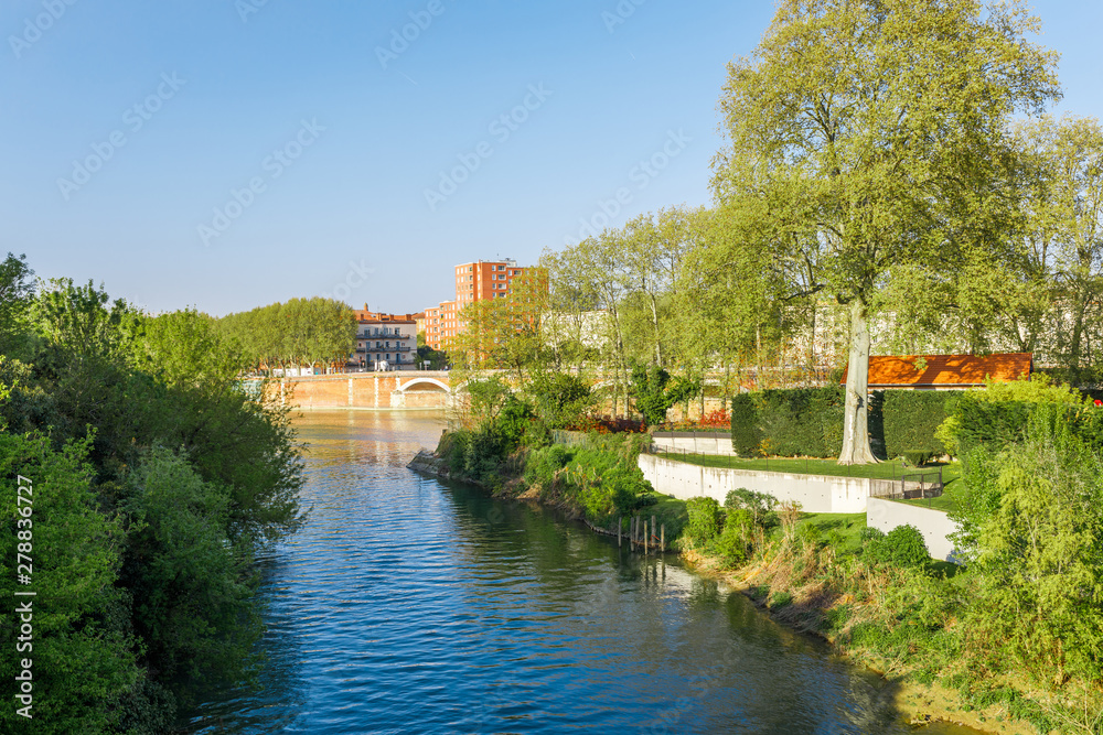 French ancient town Toulouse and Garonne river panoramic view. Toulouse is the capital of Haute Garonne department and Occitanie region, France, South Europe. Famous city and tourist destionation.