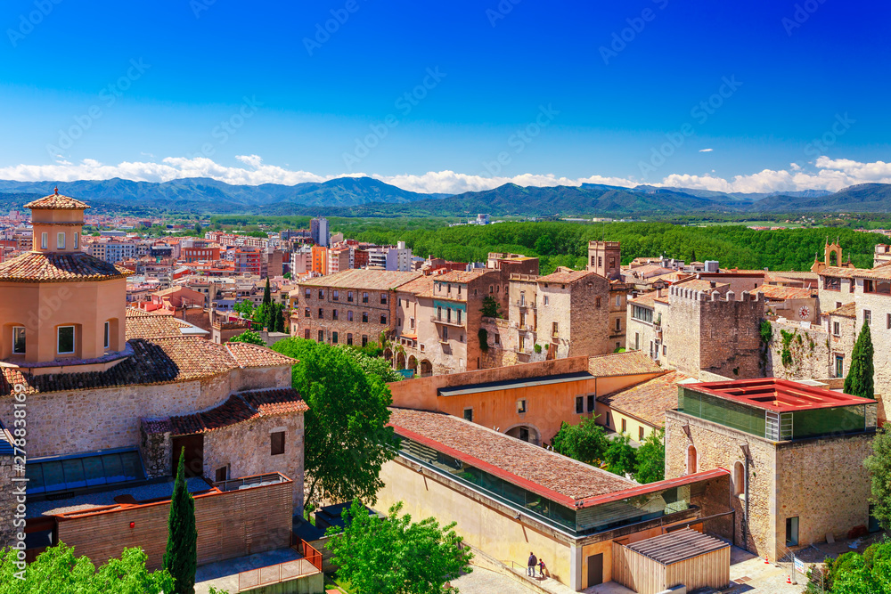 Top aerial view on Girona, Catalonia, Spain. Scenic and colorful ancient town. Famous tourist resort destination, perfect place for holiday and vacation.