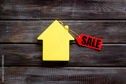 Sale labels with house in discount on wooden background top view