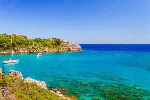 Sea skyview landscape photo Ladiko bay near Anthony Quinn bay on Rhodes island, Dodecanese, Greece. Panorama with nice sand beach and clear blue water. Famous tourist destination in South Europe © oleg_p_100