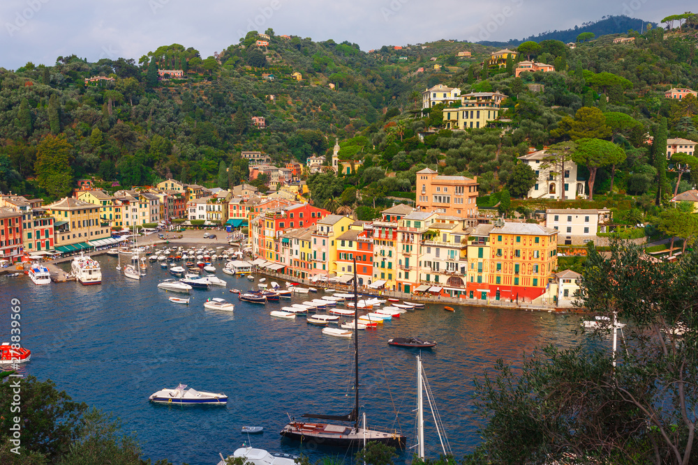 Sea landscape in Portofino, Liguria, Italy. Scenic fishing village with traditional houses and clear blue water. Summer vacation luxury rich resort with picturesque harbour and celebrity visitors