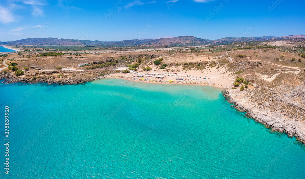 Aerial birds eye view drone photo Agia Agathi beach near Feraklos castle on Rhodes island, Dodecanese, Greece. Panorama with sand beach and clear blue water. Famous tourist destination in South Europe