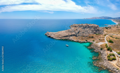 Aerial birds eye view drone photo Feraklos castle near Agia Agathi beach on Rhodes island, Dodecanese, Greece. Panorama with sand and clear blue water. Famous tourist destination in South Europe
