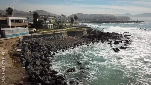 Aerial & fly over view of some artificial rocky seashore of Baja California photo