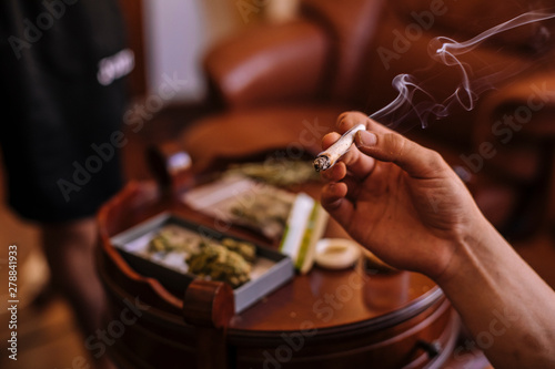 Close-up of hands with a joint of marijuana