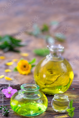 Composition with essential oils and flowers. Alternative medicine, bottle potion and oil