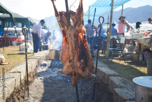 Meat roasted on the stick by a Chilean gaucho in Lonquimay, Chile photo