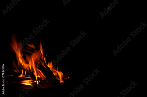 fire in movement that are deposited from a bonfire in the middle of the darkness of magic night