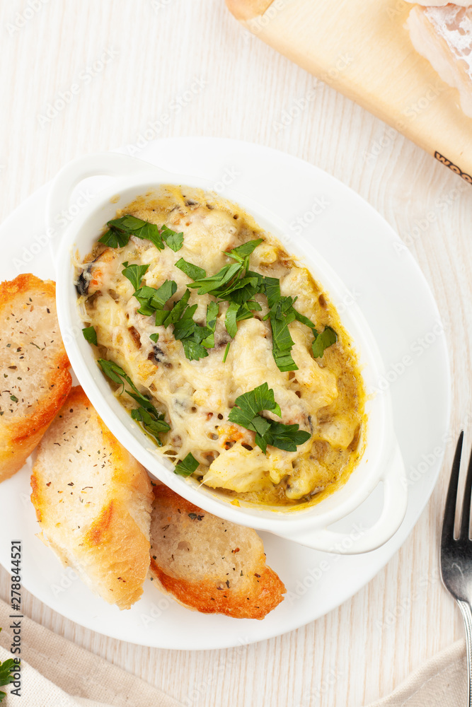 Cod casserole with mussels, creamy gravy, parmesan cheese and provencal herbs, served with french baguette and garlic oil