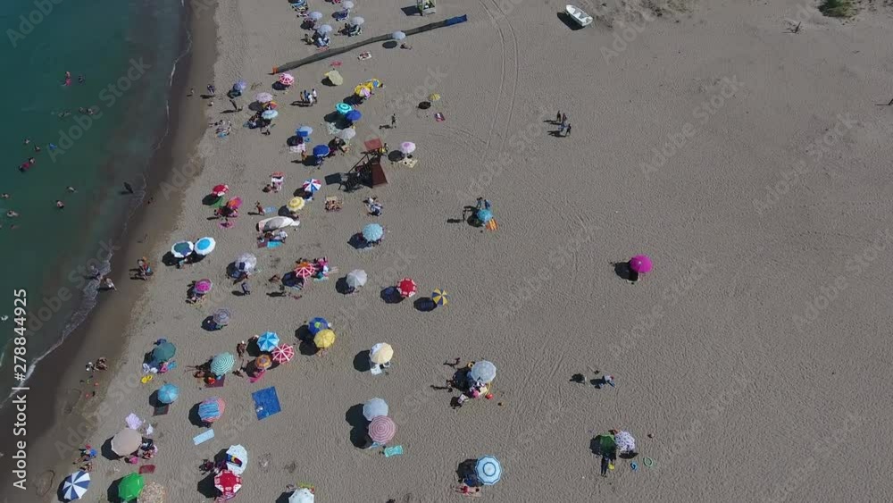 COLORFUL UMBRELLAS IN BEACH, CROWDED COAST FROM THE AIR COLORFUL UMBRELLAS IN BEACH, CROWDED COAST FROM THE AIR