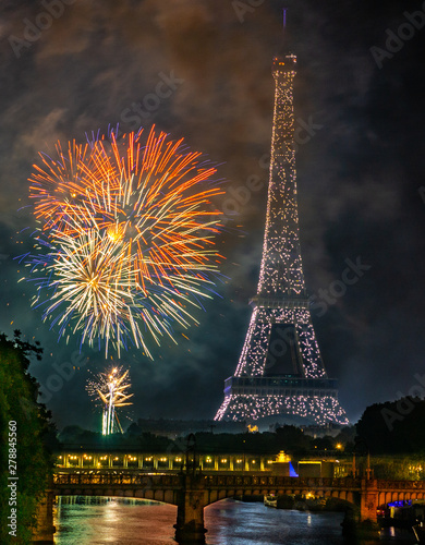 France celebrating Independence day Bastille day in Paris near Eiffel tower with fireworks. Seine river, pont du bir-hakeim, and railway captured in one frame with the Eiffel tower and the fireworks.