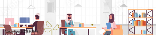corporate staff employees working in creative co-working open space arabic coworkers businesspeople sitting at workplace and discussing new project modern office interior portrait horizontal