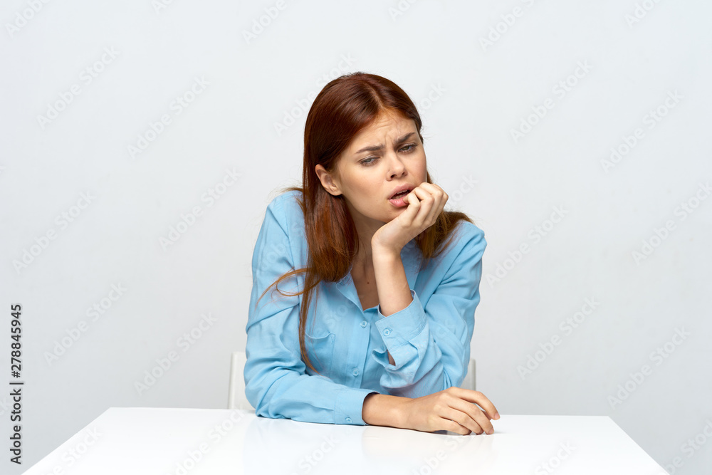portrait of a young woman sitting on sofa and looking at the camera portrait of a young woman sitting on sofa and looking at the camera
