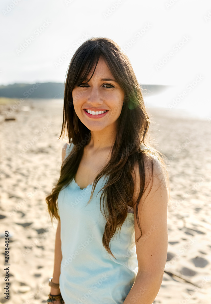 Portrait of a smiling young woman on the beach Portrait of a smiling young woman on the beach