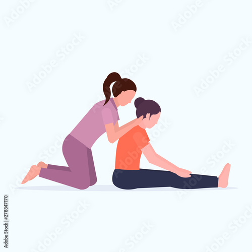 female personal trainer doing stretching exercises with girl fitness instructor helping woman to stretch muscles workout concept flat full length