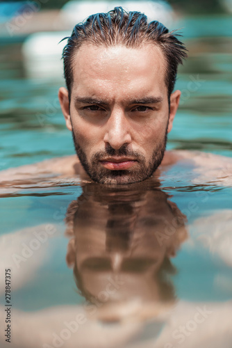 Desirable young guy emerging from water © Teodor Lazarev