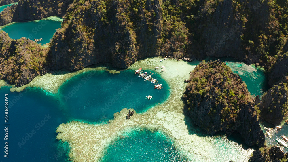 Aerial drone lagoons and coves with blue water among the rocks. lagoon, mountains covered with forests. Seascape, tropical landscape. Palawan, Philippines, Busuanga
