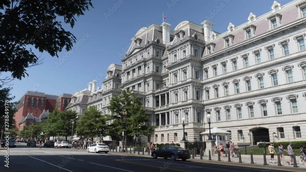 WASHINGTON, D.C. - Circa July, 2019 - A daytime exterior establishing shot of the Eisenhower Executive Office Building as traffic passes by on 17th Street. WASHINGTON, D.C. - Circa July, 2019 - A daytime exterior establishing shot of the Eisenhower Executive Office Building as traffic passes by on 17th Street.