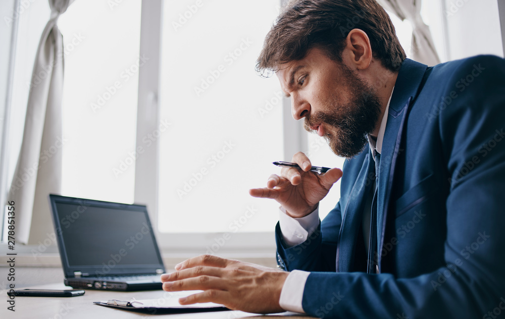 businessman working on laptop in an office businessman working on laptop in an office