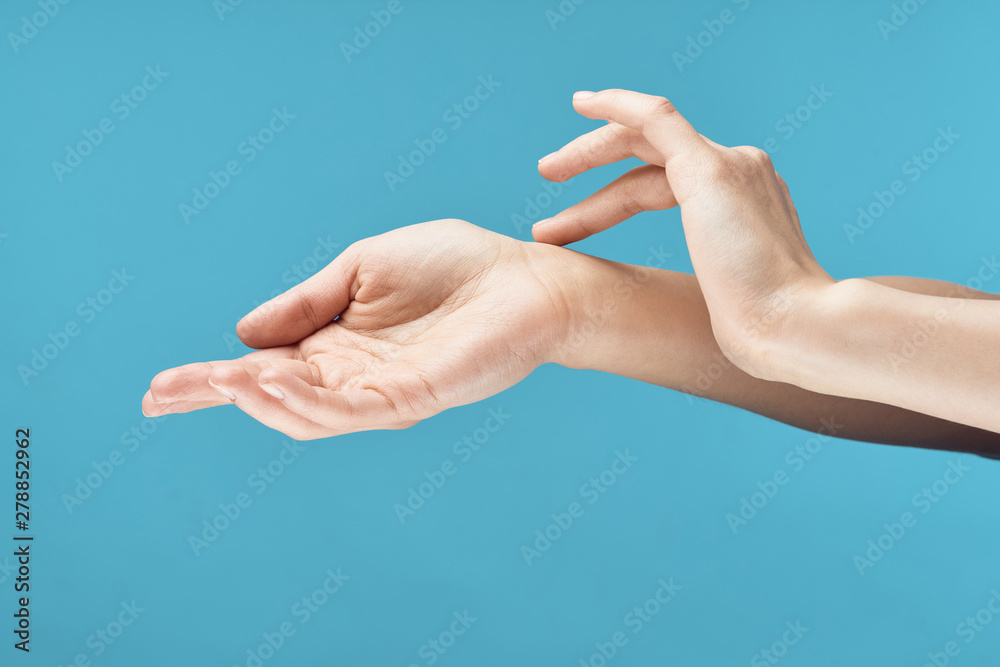 hand with pill on blue background