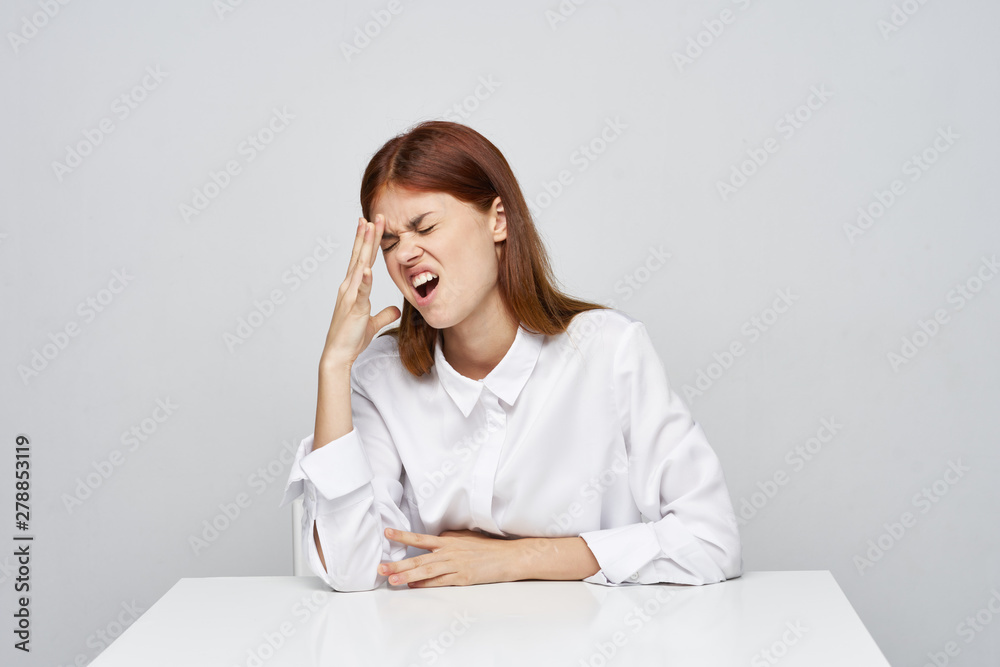 young woman sitting at desk and talking on phone young woman sitting at desk and talking on phone