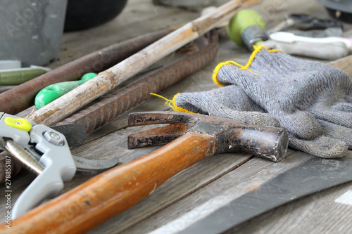 scatter of tools on dirty wooden table