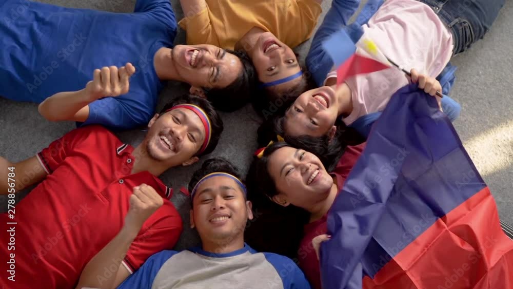 filipino group of people holding philippines flag celebrating independence day