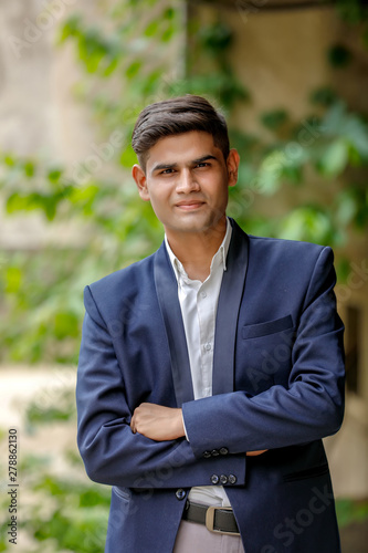 Portrait of a young Indian successful businessman wearing suit and Spectacles