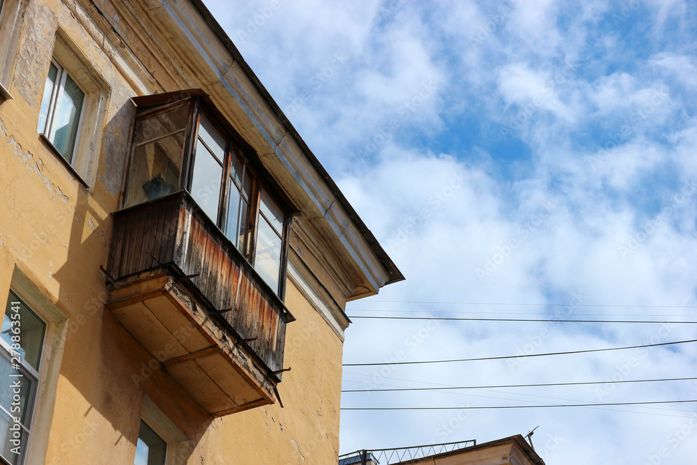 detail of a building old wooden balcony against blue sky Saint Petersburg russia