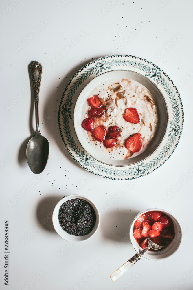 From above served oatmeal with strawberry and chia seeds From above served oatmeal with strawberry and chia seeds