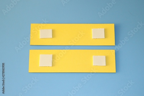yellow paper with a sticky tape on a blue background